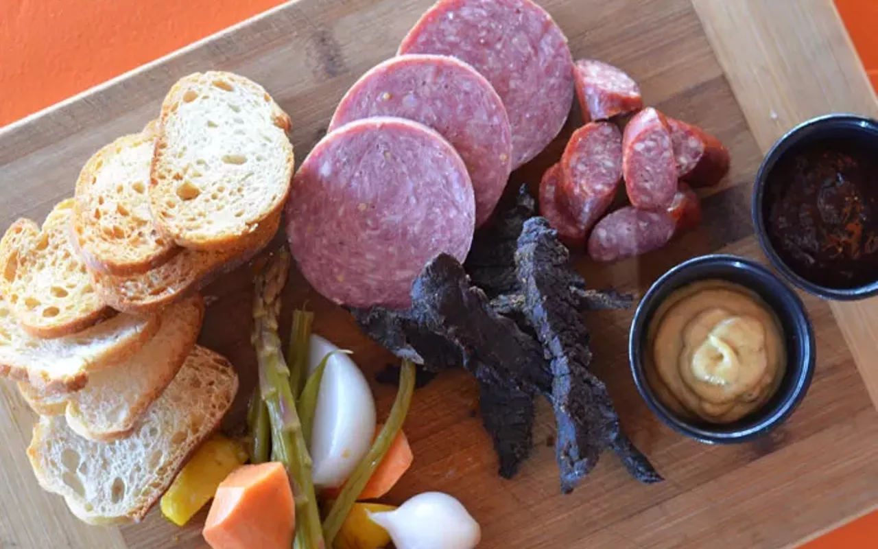 the meaty bits board features house-made sausages, jerky and pickles with fig jam, garlic mustard and crostini.